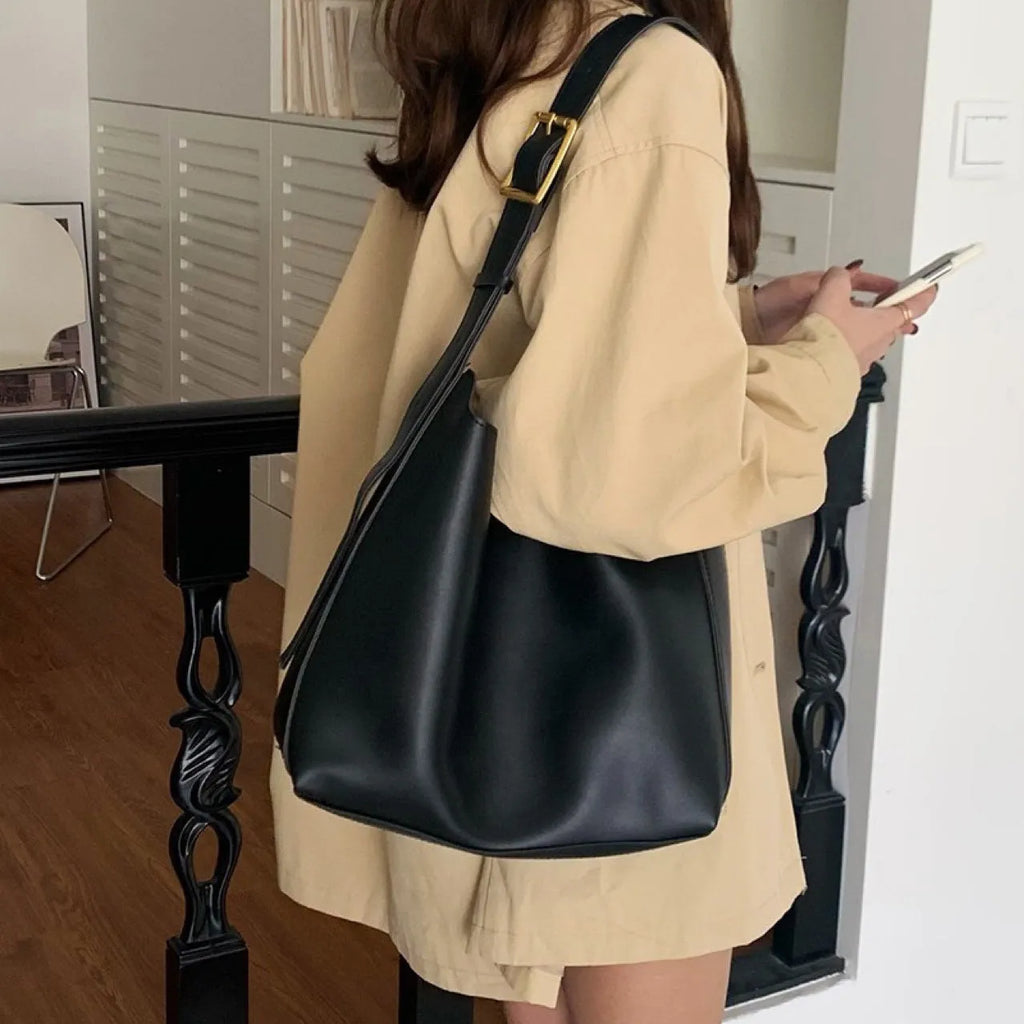 Women's soft PU leather shoulder bag with swing threads detail in black and brown colour options