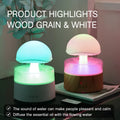 White cloud-shaped humidifier emitting mist with LED lights and falling water droplets
