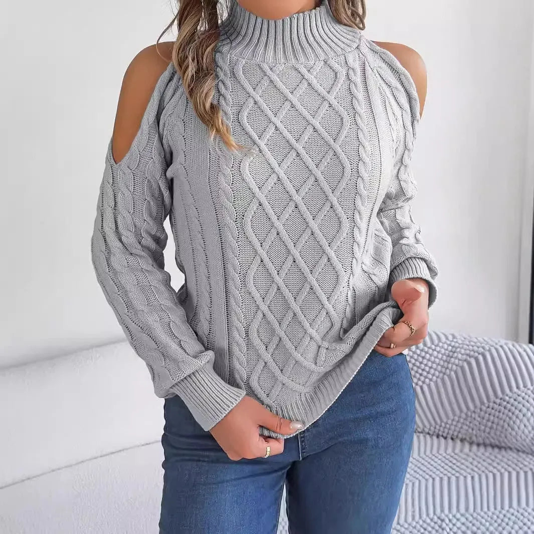 Woman wearing a grey twisted strapless sweater with half-high collar and lantern sleeves.