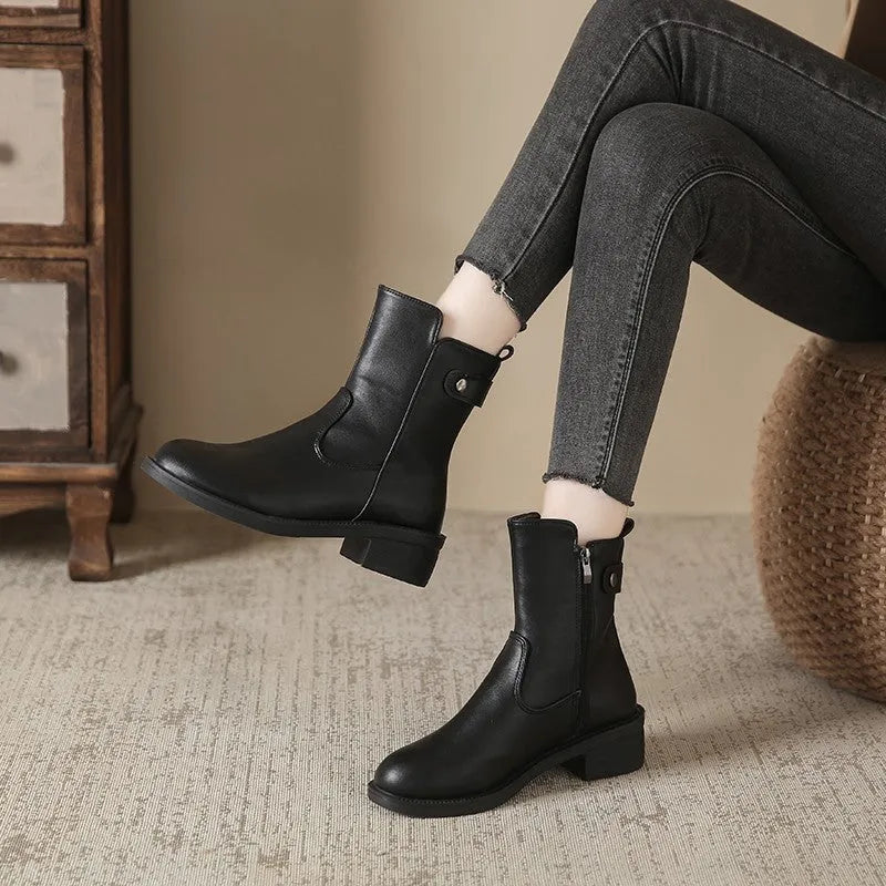 Black women's ankle boots with side zipper and round toe on low rubber heel