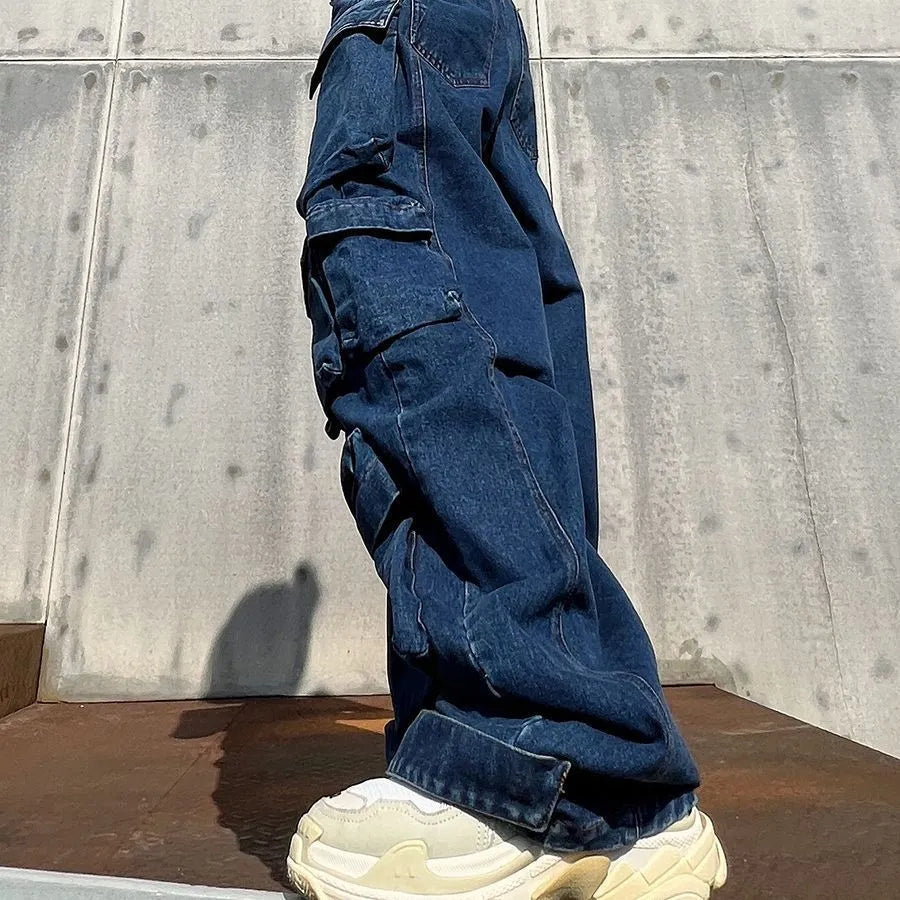 Distressed dark blue wide-leg jeans with high waist and multiple pockets on mannequin