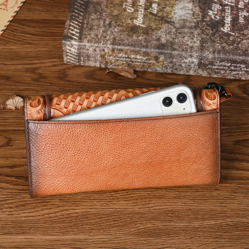 Women's brown embossed floral pattern tri-fold leather wallet showing open compartments