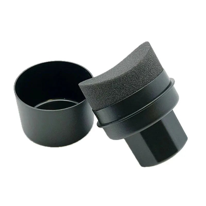 Black and red tyre polishing sponge brushes with protective lids on a white background