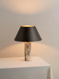 Black marble table lamp with modern design on wooden surface