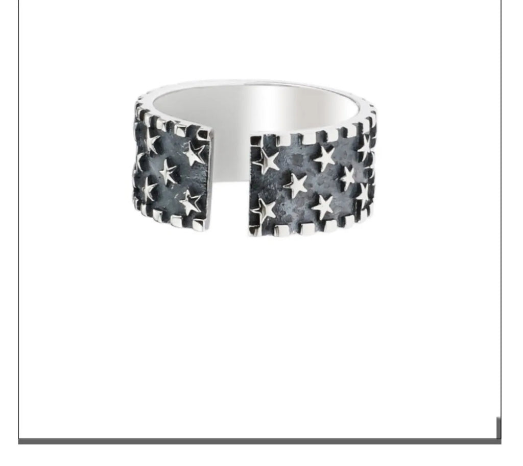Adjustable sterling silver ring showing a geometric multi five pointed star pattern on the band.