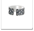 Adjustable sterling silver ring showing a geometric multi five pointed star pattern on the band.