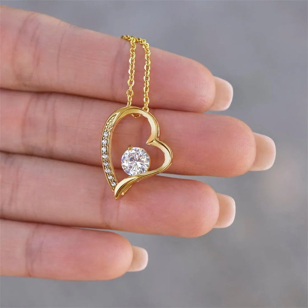 Hollow openwork heart pendant necklace on chain in silver or gold colour with gift box packaging.