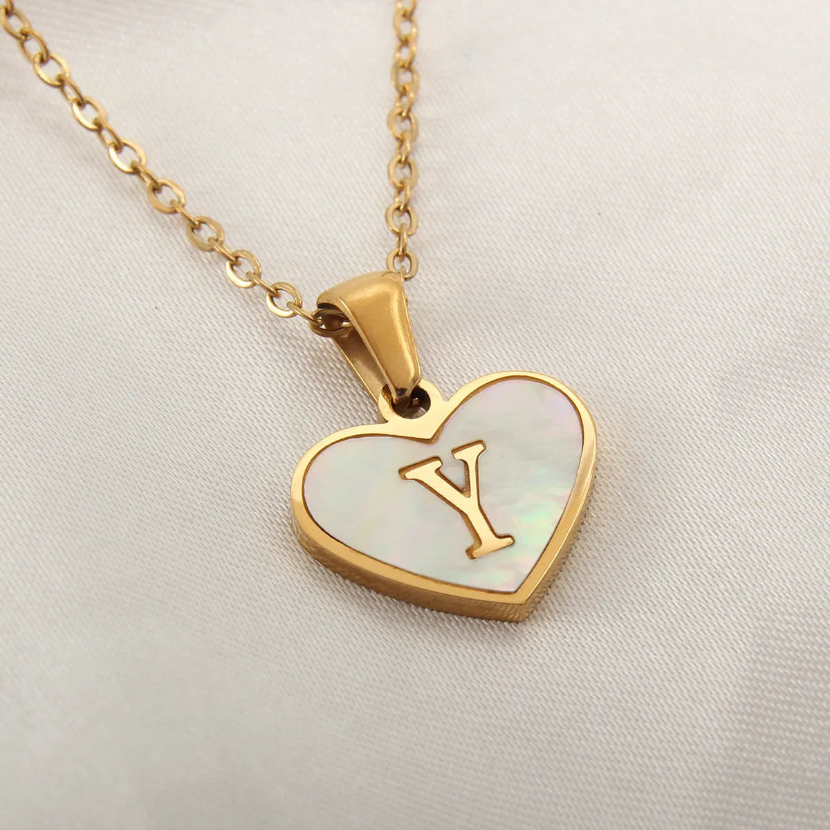 Gold plated heart necklace with white shell detail on an adjustable chain