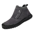 Lightweight grey welder safety shoe with steel toe cap and lace-up front on a worksite background.