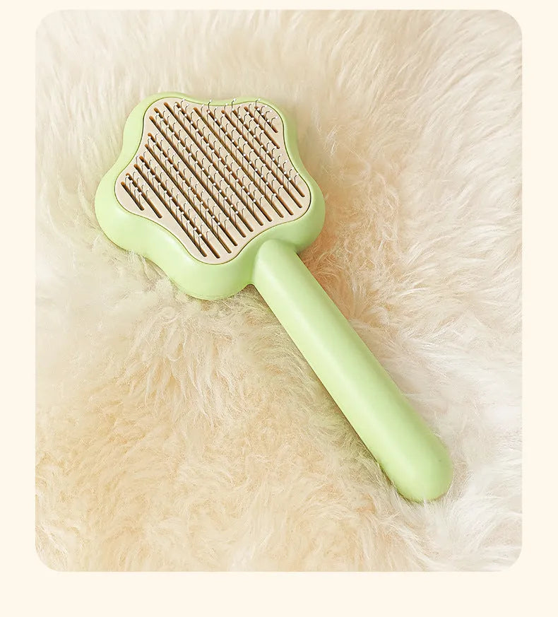 Green and yellow self-cleaning stainless steel cat comb grooming tool measuring 20 cm.