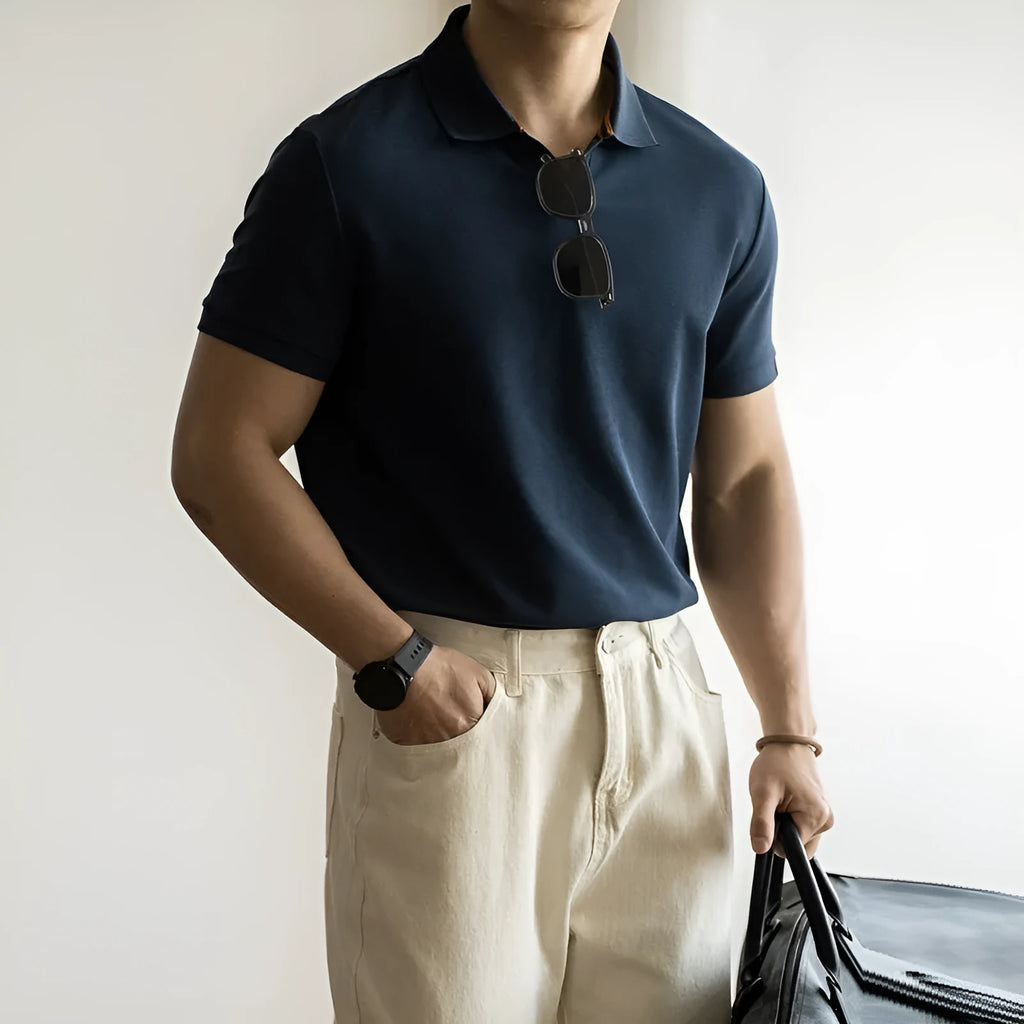 American-style light blue cotton blend short-sleeve polo shirt laid flat, showing regular fit and button placket.