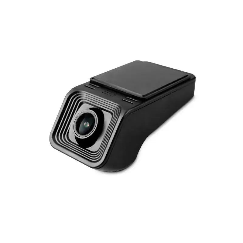 Black car dash cam mounted on windscreen with forward-facing lens and power cable