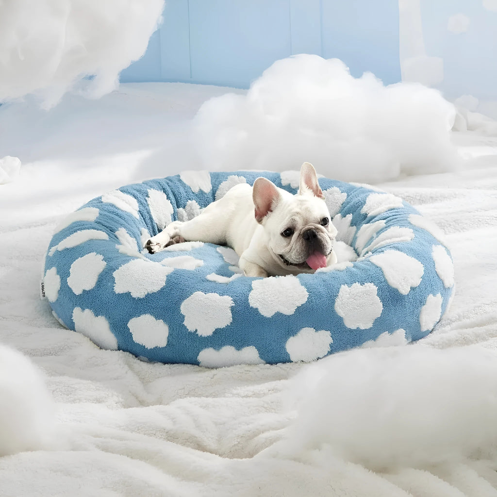 Round blue and white plaid dog bed with a removable cover on a plastic base