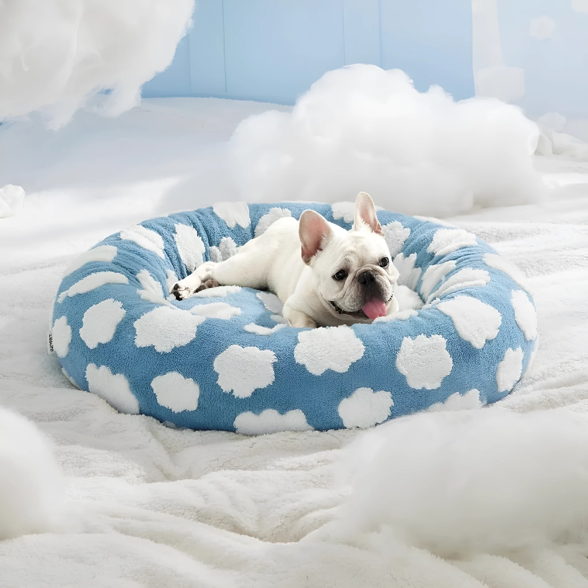 Round blue and white plaid dog bed with a removable cover on a plastic base