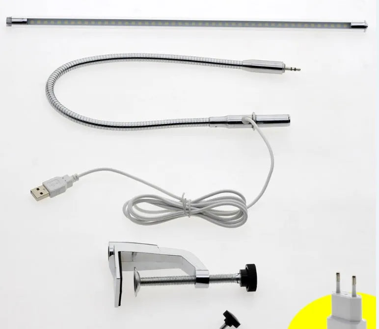 Silver long arm LED clip table lamp with USB cable, shown illuminating a nail art workspace.