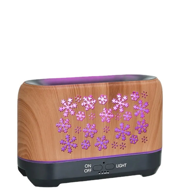 Christmas snowflake pattern ultrasonic aromatherapy humidifier with colourful flame light effect on a desk.