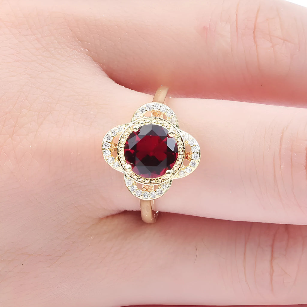 Copper ring with fruit-shaped setting holding a faceted zircon stone.