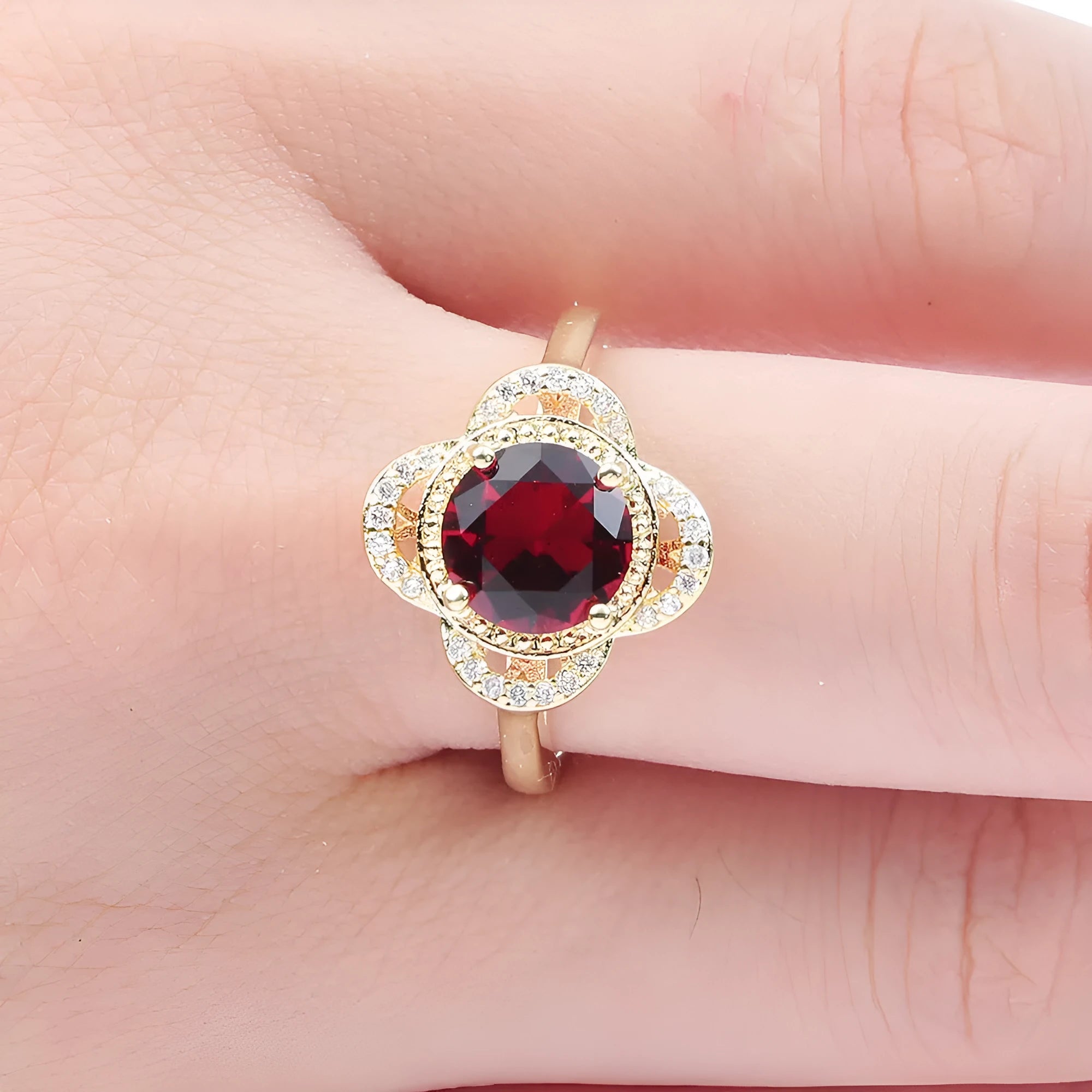 Copper ring with fruit-shaped setting holding a faceted zircon stone.