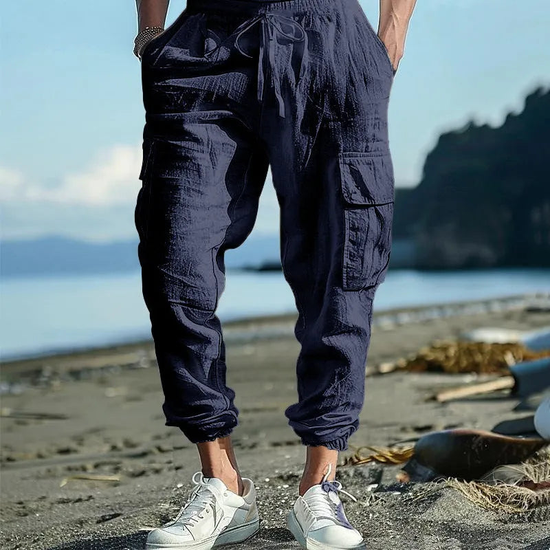 Men's linen casual trousers in Army Green with multi-pockets and an ankle tie closure.