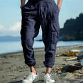 Men's linen casual trousers in Army Green with multi-pockets and an ankle tie closure.