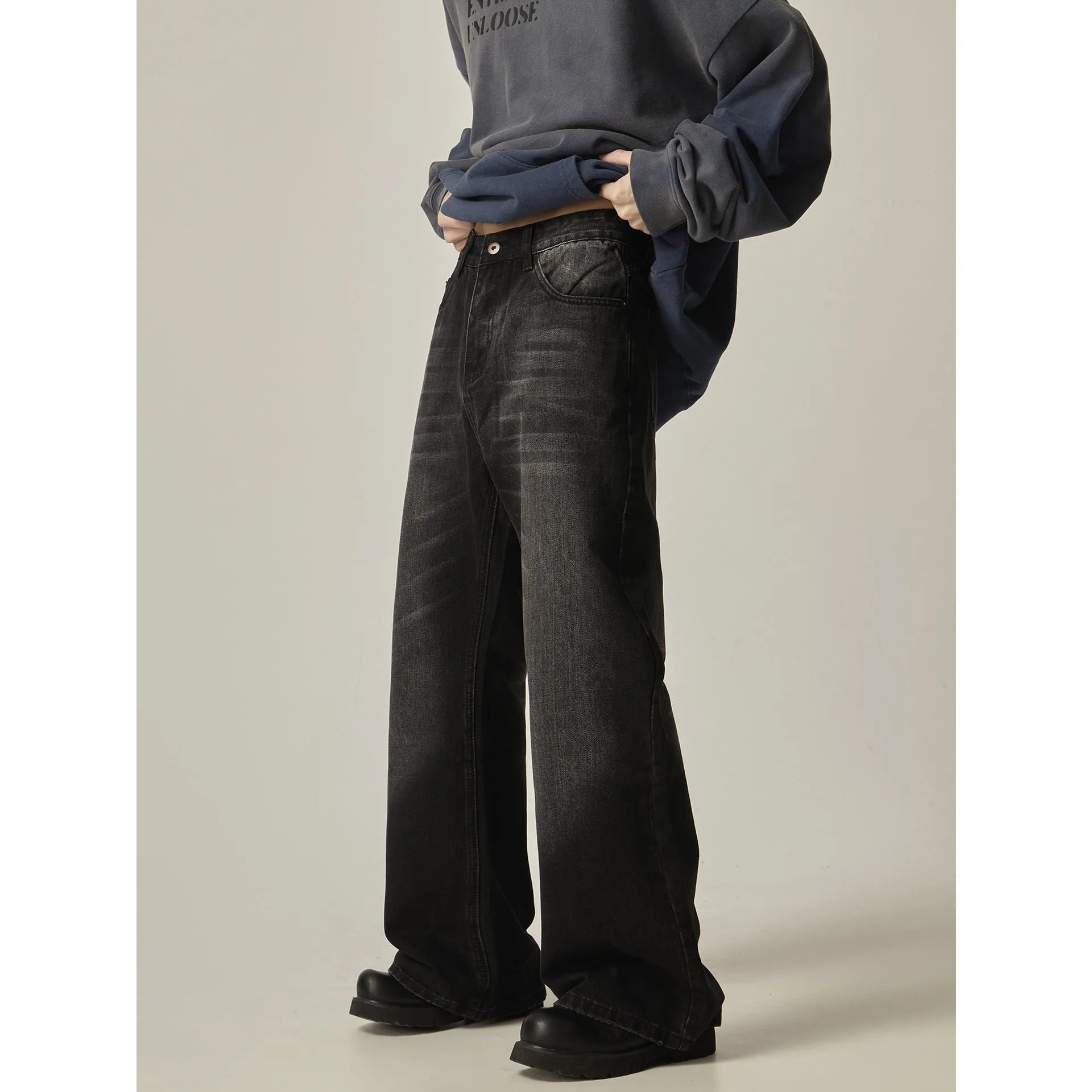 Black retro straight leg jeans with loose fit and zipper fly on hanger