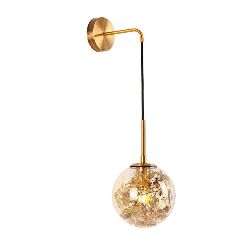 Modern glass wall lamp in golden flower finish mounted beside bed