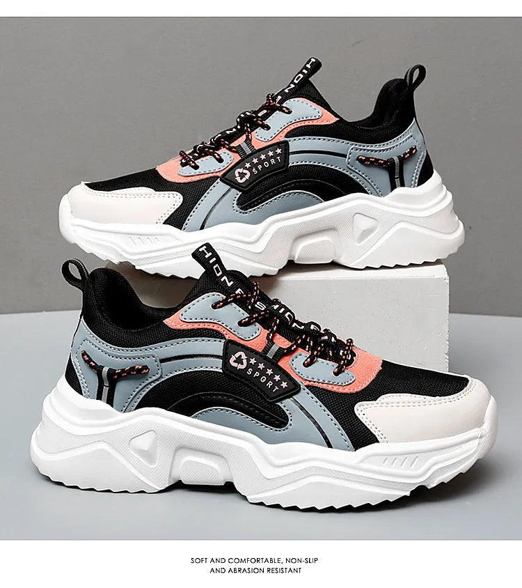 Women's white thick-soled casual sneakers with mesh upper, round toe, and buckle detail.