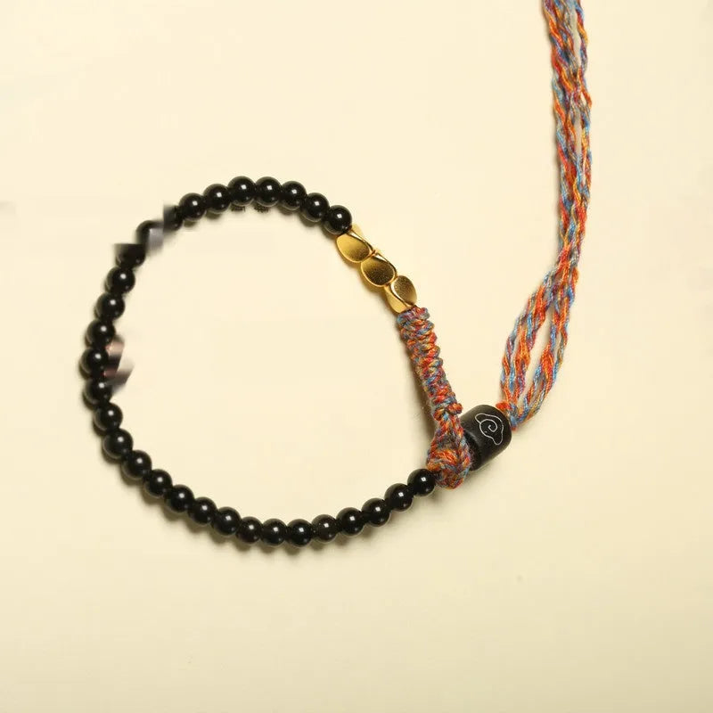 Hand-woven obsidian carrying strap bracelet showing textured detail and adjustable 15.5-16cm length