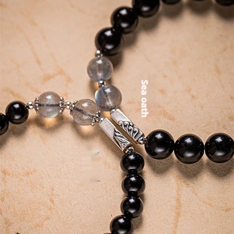 Obsidian couple bracelet DIY kit with 8mm and 10mm black beads and cord for assembly.