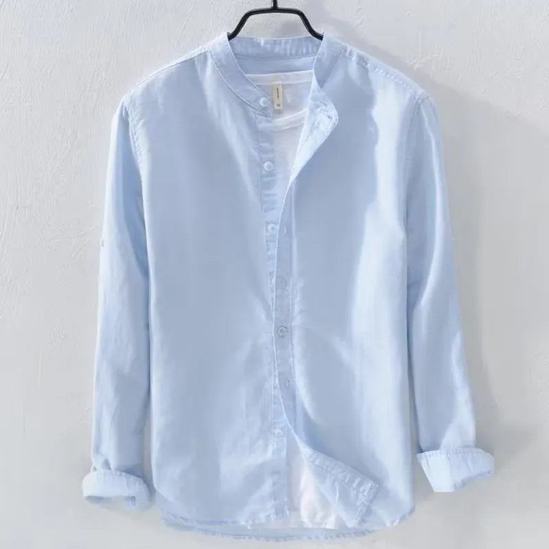 Loose fit long sleeve linen shirt in solid colour on hanger showing casual collar and button front