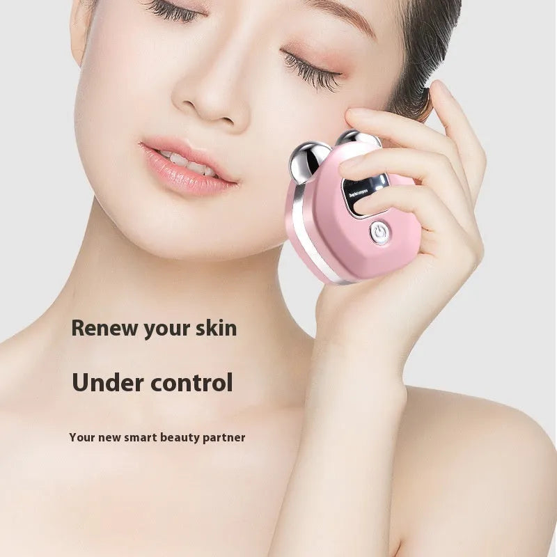 Portable white hot compress micro current facial massage instrument with dual rollers on a pink background.