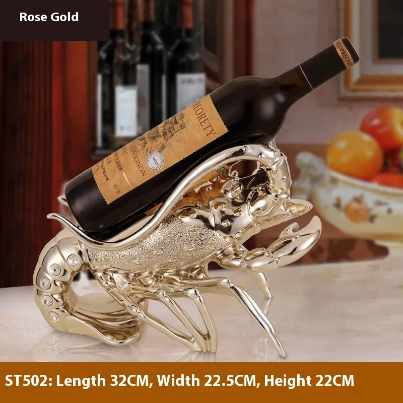 Rose gold and silver lobster-shaped plastic and resin wine rack ornament on a tabletop.