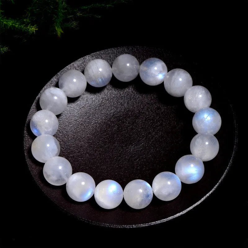 Natural blue moonlight round moonstone bead bracelet on a white background showing polished spherical beads.