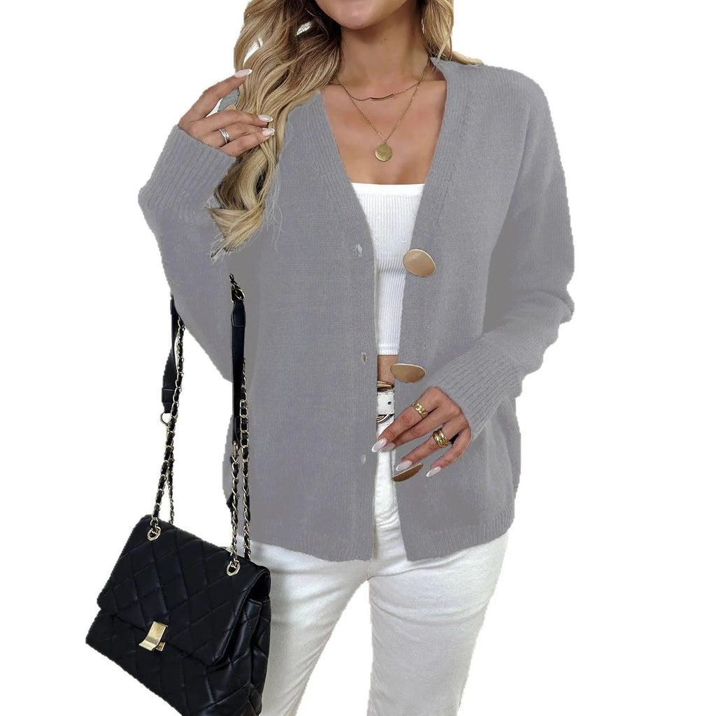 A gray women's long sleeve deer plush sweater coat with princess sleeves on a hanger.