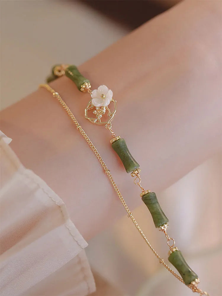 Handmade olivine bracelet with double layer design and twin charms on wrist