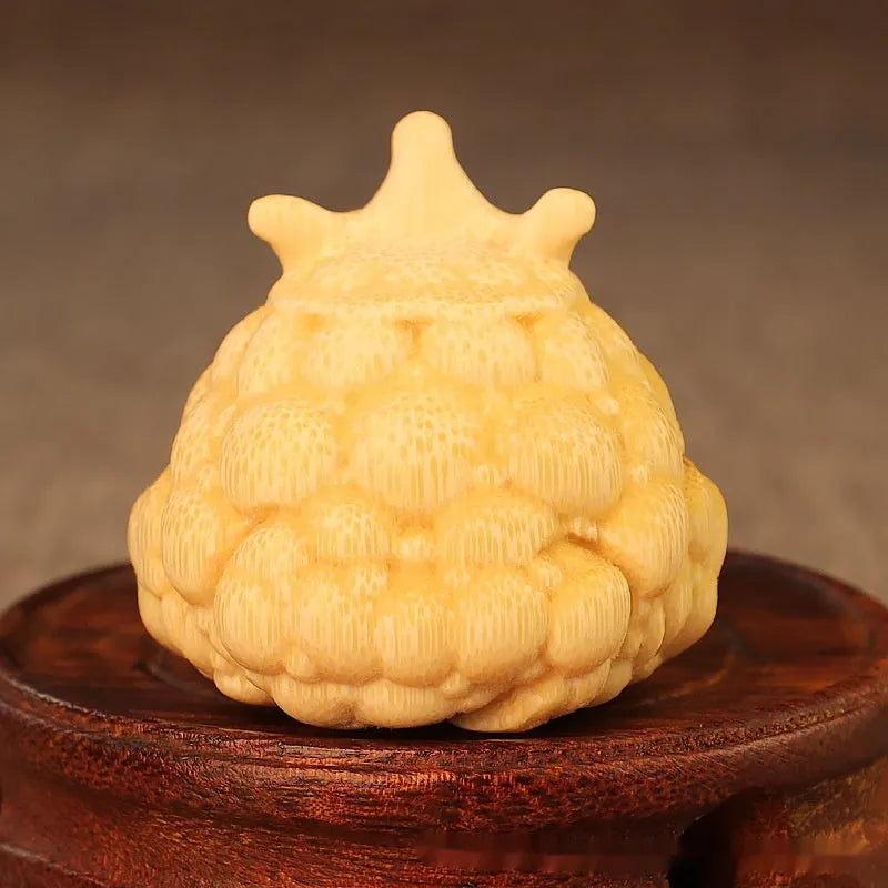 Solid bamboo carving of a Crown Princess Toad ornament with live eye design.