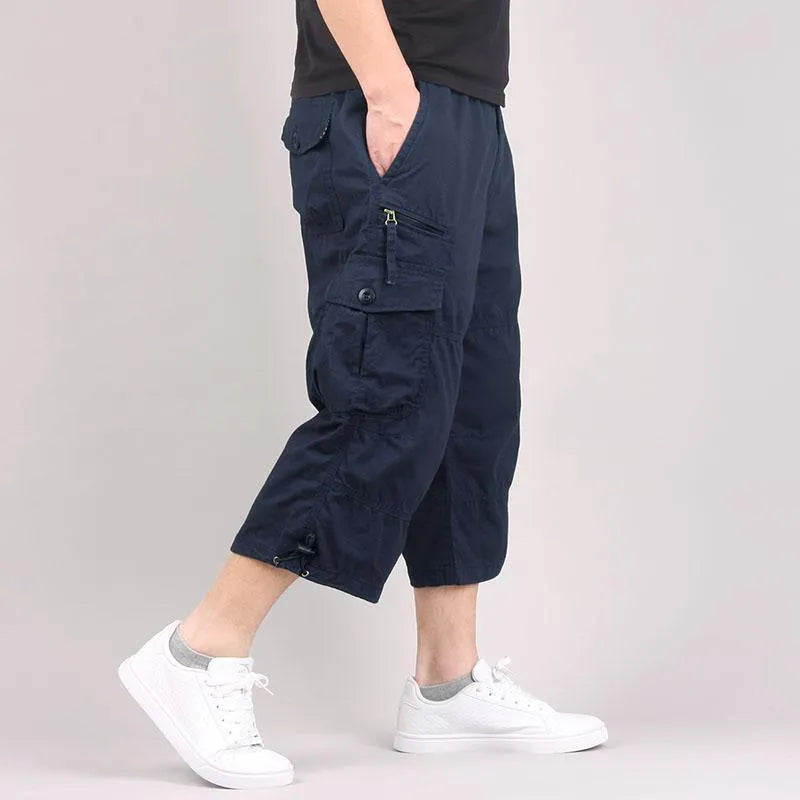 Men's loose fit cotton cropped casual pants in khaki, shown on a model.