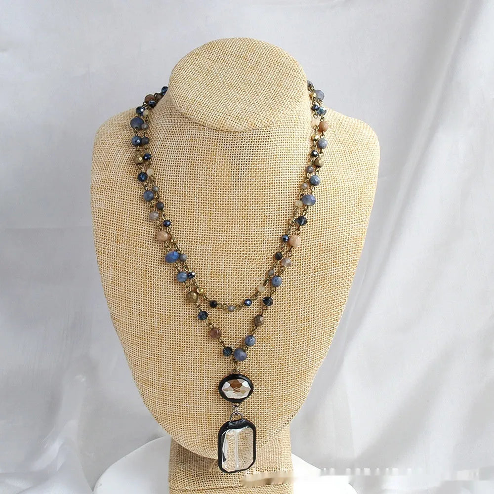 Tribal style two-layer necklace with glass and stone pendants in beige and blue on adjustable chain