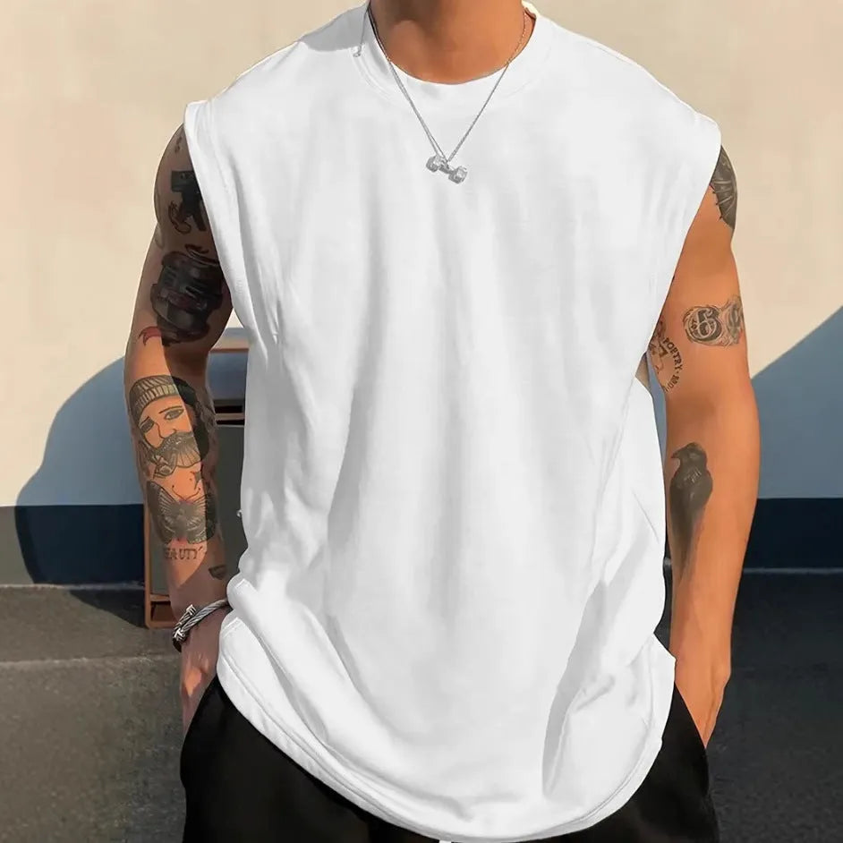 Men's loose fit cotton sleeveless t-shirt in a solid colour, shown on a hanger.