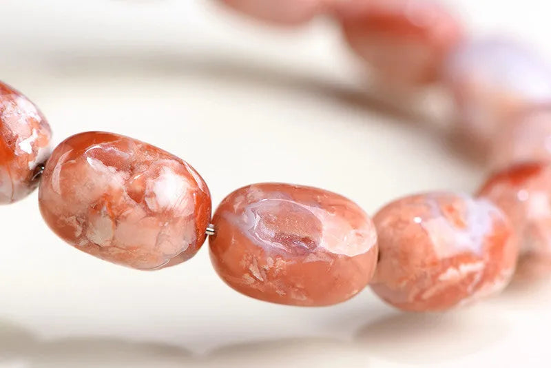 Agate barrel bead bracelet with cherry blossom colour and a ruyi element
