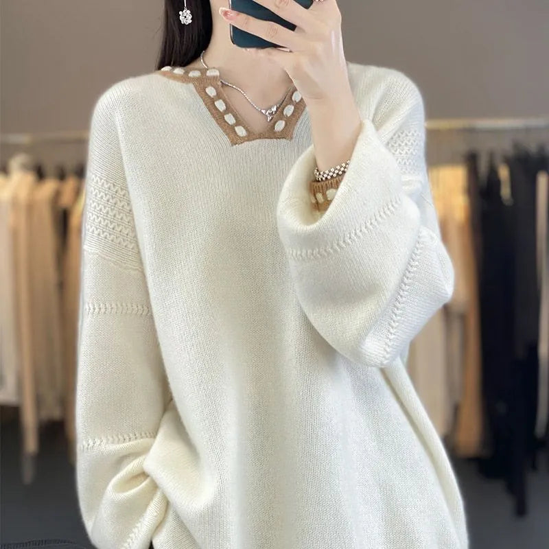 Camel coloured women's V-neck viscose pullover sweater with long sleeves on a hanger.