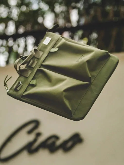 Medium canvas crossbody messenger bag in military green with zipper closure and shoulder strap