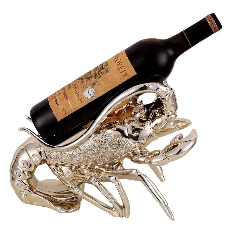 Rose gold and silver lobster-shaped plastic and resin wine rack ornament on a tabletop.