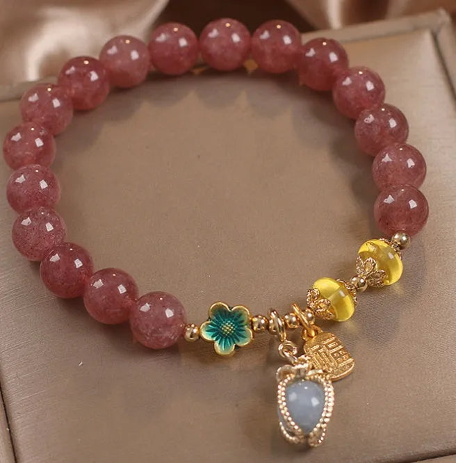 Red strawberry quartz bead bracelet with alloy chain and sparkling rhinestone details.