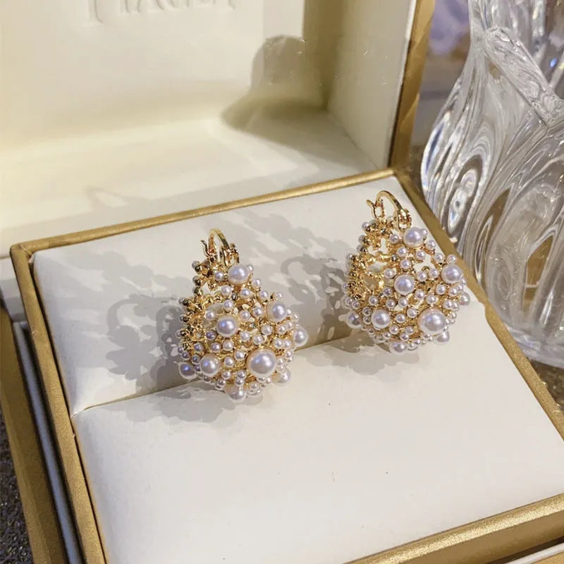 Women's gold flower basket earrings with small beads and pearl inlay details