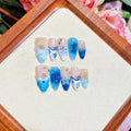 Blue summer ice transparent fake nails with hand-painted carved design, showing four size categories XS S M L