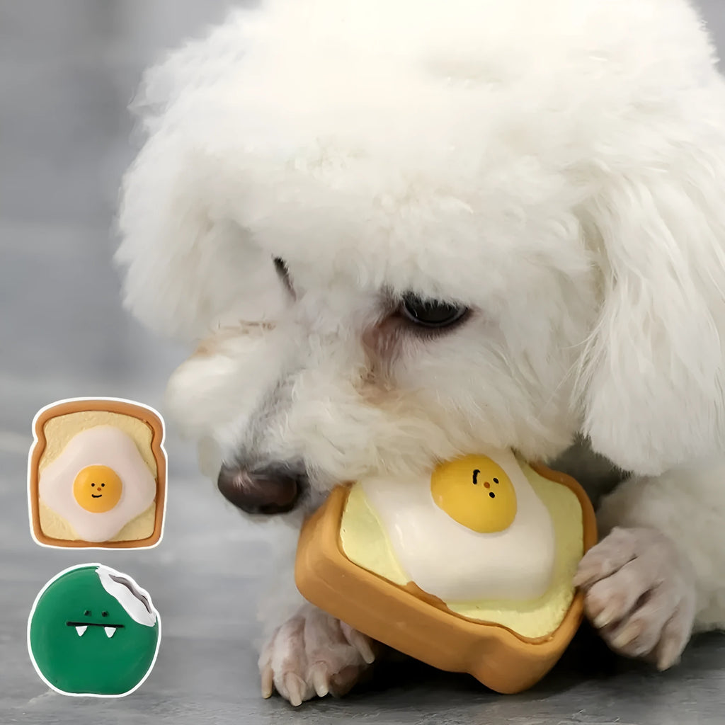 Yellow and green bread-shaped latex dog squeaky toy with cartoon pattern on a white background.