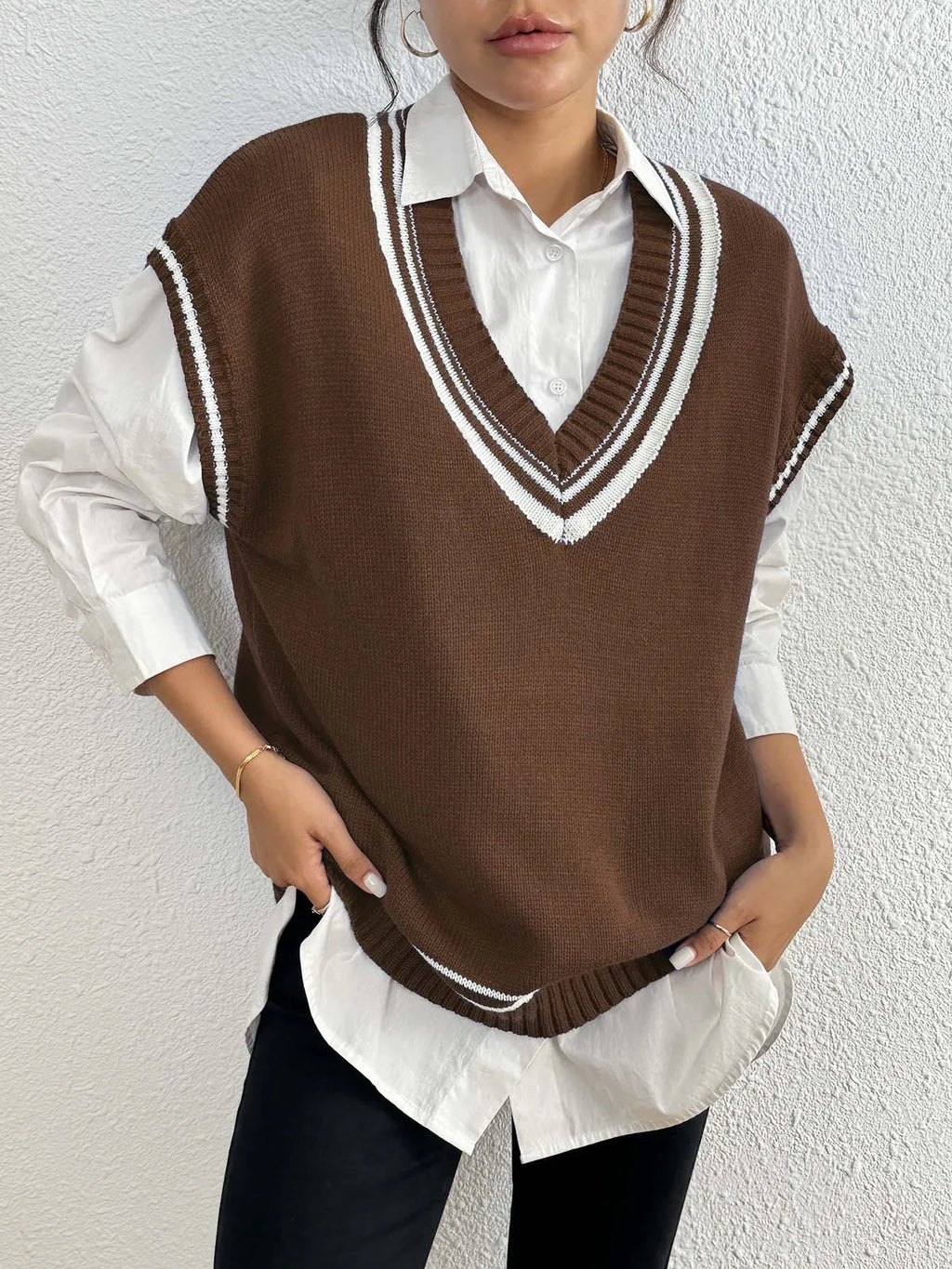Women's loose fit pullover vest sweater in a college style, shown in blue.