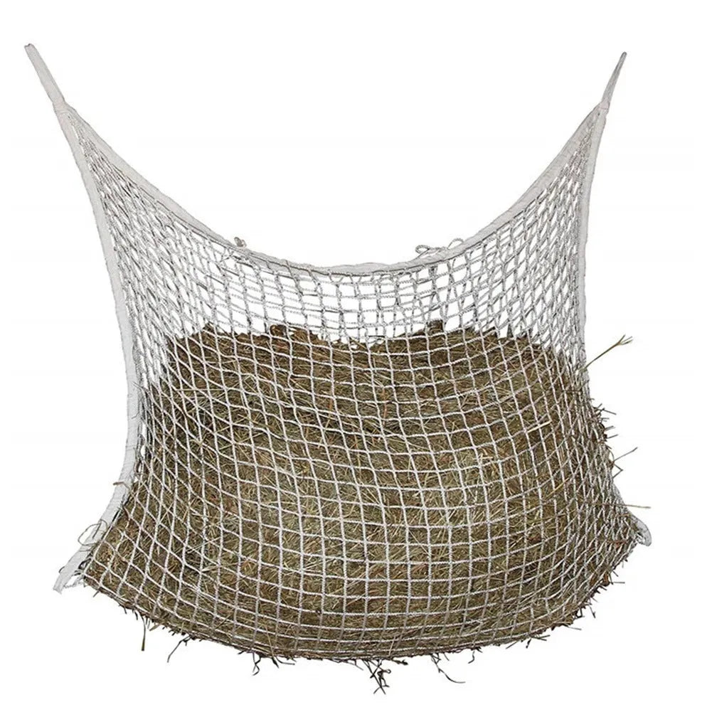 Black woven PE rope grid feeding bag hung on a fence, suitable for horses and cattle.