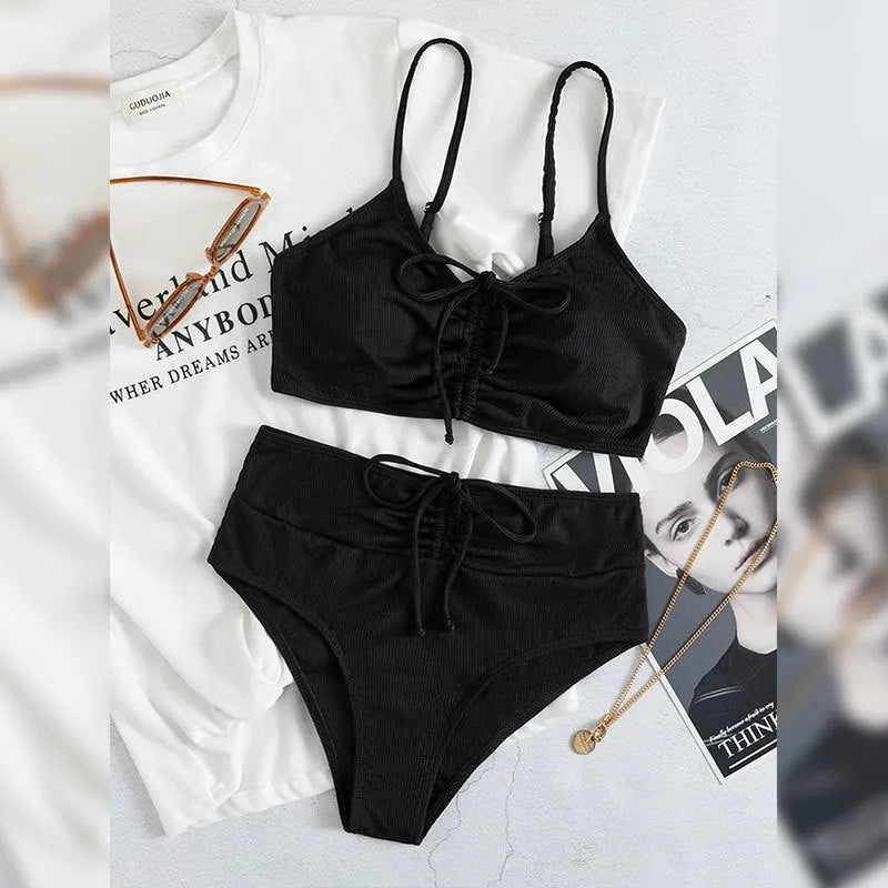 Black women's swimsuit set with sling bikini top and high-waist shorts with side splits